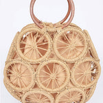 Natural raffia woven circle handbag with wooden ring handles and sunburst pattern—neutral beach tote