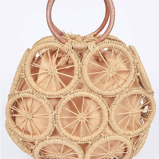 Natural raffia woven circle handbag with wooden ring handles and sunburst pattern—neutral beach tote