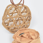 Natural raffia woven circle handbag with wooden ring handles and sunburst pattern—neutral beach tote