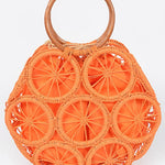 Vibrant orange woven circle purse featuring raffia wheel design and wooden handles—colorful summer tote.