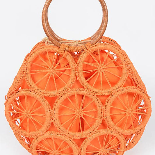 Vibrant orange woven circle purse featuring raffia wheel design and wooden handles—colorful summer tote.