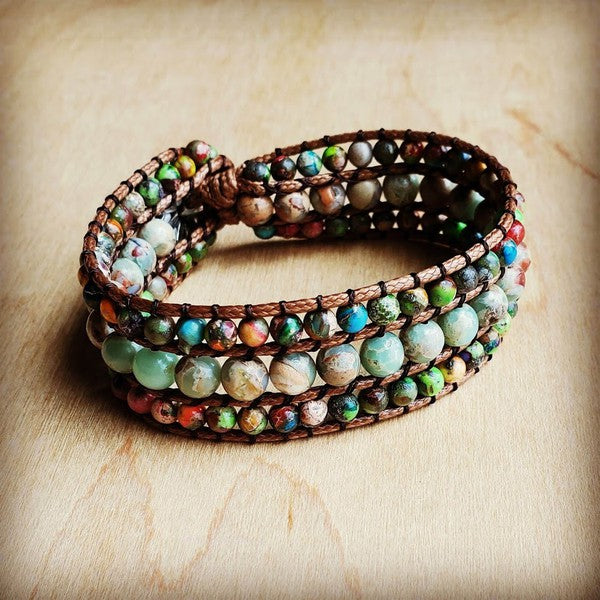 Handmade leather wrap bracelet with colorful semi-precious stone beads and a silver floral button clasp.
