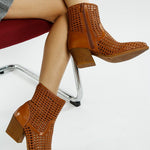 Tri-color collection of women’s woven faux-leather ankle boots with pointed toe and block heel—shown in black, cream, and tan shades.