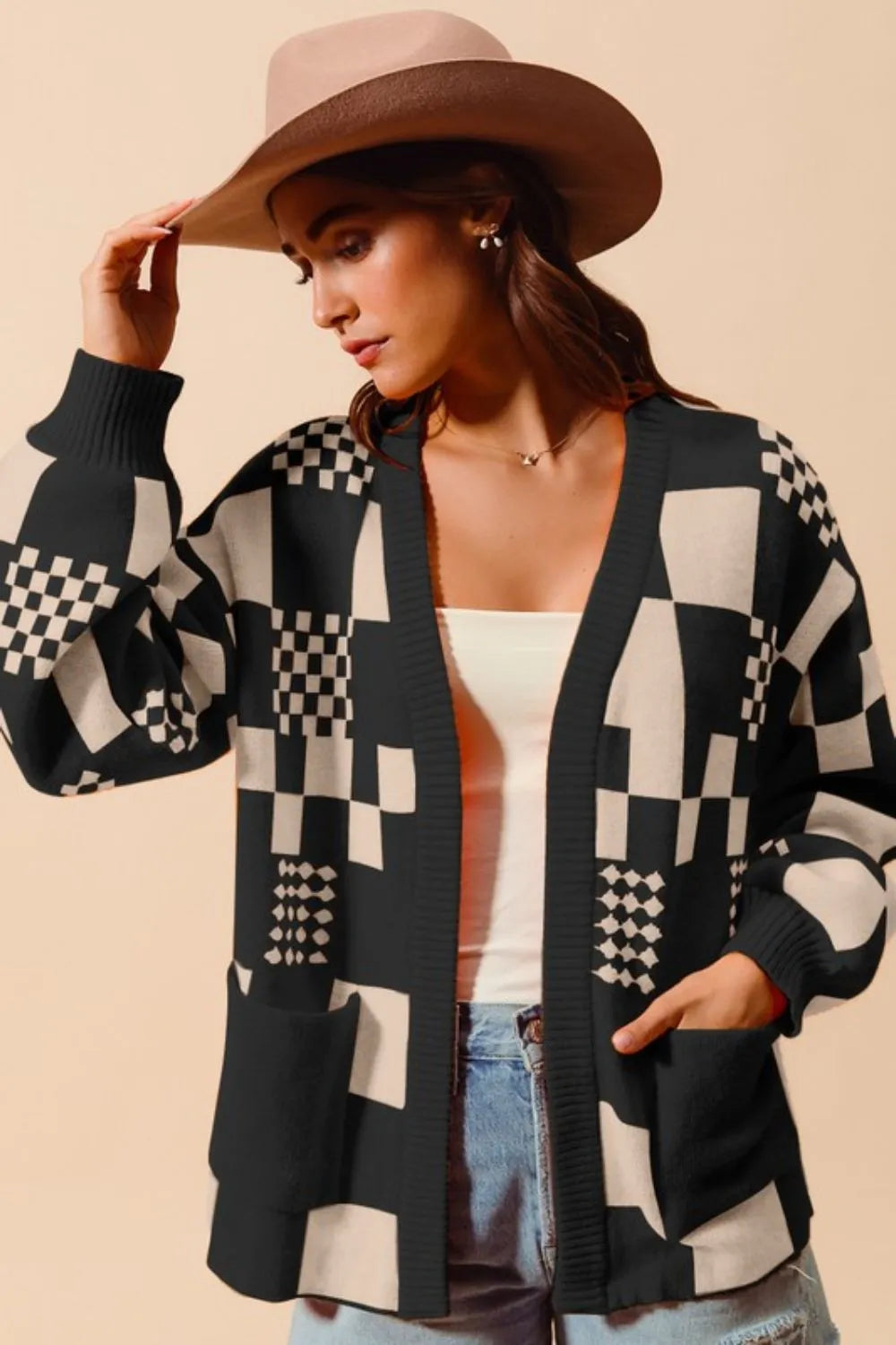 Women's black and cream checkerboard patchwork knit cardigan with open front and front pockets – cozy geometric print sweater for layering.