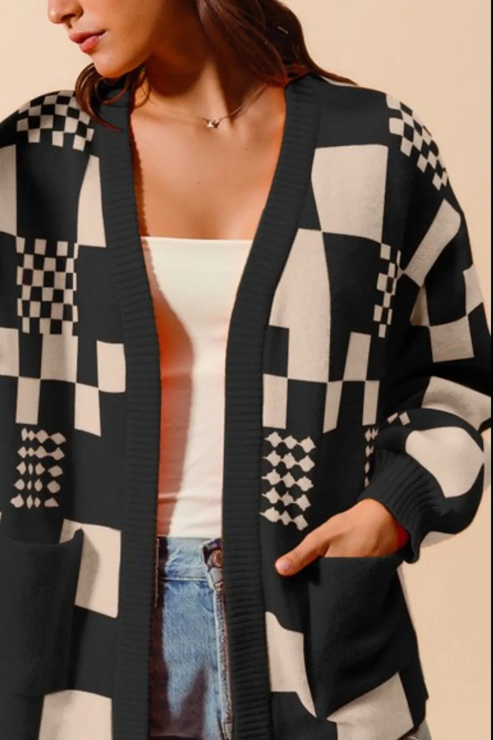 Women's black and cream checkerboard patchwork knit cardigan with open front and front pockets – cozy geometric print sweater for layering.