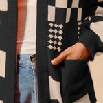 Women's black and cream checkerboard patchwork knit cardigan with open front and front pockets – cozy geometric print sweater for layering.