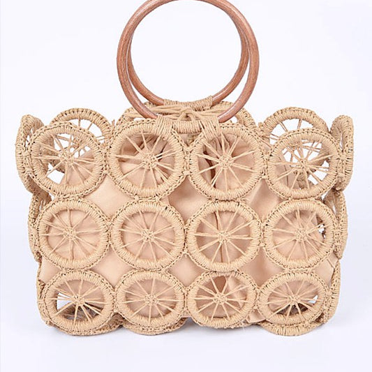 Natural raffia circle-grid handbag featuring wooden round handles and beige drawstring lining.