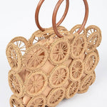 Natural raffia circle-grid handbag featuring wooden round handles and beige drawstring lining.