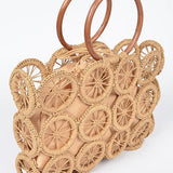 Natural raffia circle-grid handbag featuring wooden round handles and beige drawstring lining.