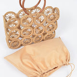 Unlined natural raffia circle-grid tote beside removable beige drawstring pouch insert.