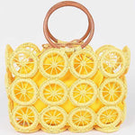 Sunny yellow woven circle-grid tote bag with wooden ring handles and matching fabric lining.