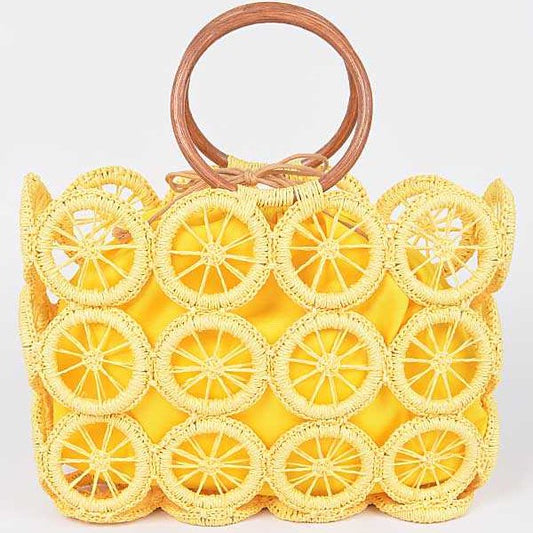 Sunny yellow woven circle-grid tote bag with wooden ring handles and matching fabric lining.