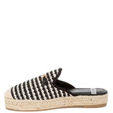 Women’s woven raffia mule espadrille with gold horse-bit hardware and jute platform, shown in black-ivory and tan-white color options.
