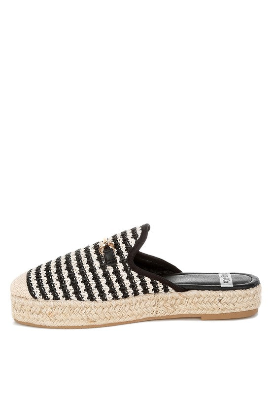 Women’s woven raffia mule espadrille with gold horse-bit hardware and jute platform, shown in black-ivory and tan-white color options.