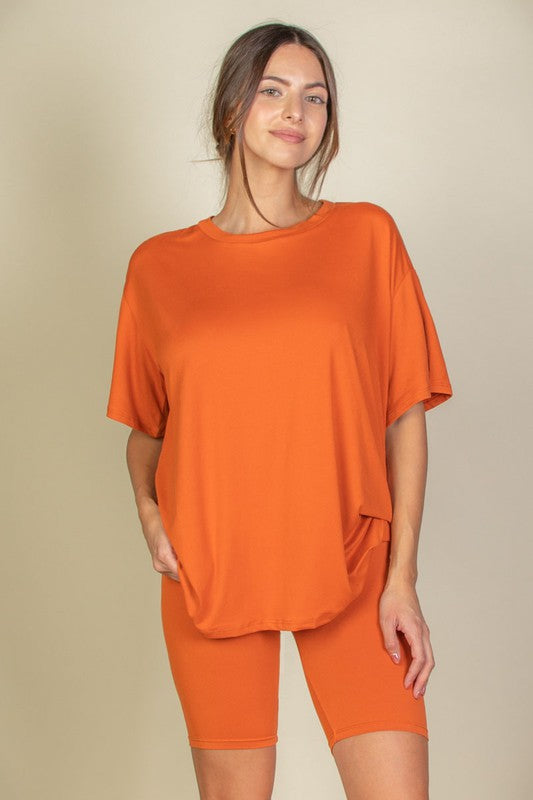Women's oversized two-piece lounge set featuring a relaxed fit short-sleeve tee and high-waisted biker shorts, available in multiple vibrant colors. Perfect for casual wear, workouts, or athleisure style.