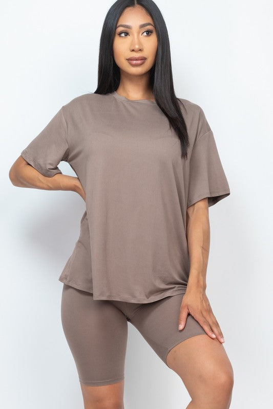 Women's oversized two-piece lounge set featuring a relaxed fit short-sleeve tee and high-waisted biker shorts, available in multiple vibrant colors. Perfect for casual wear, workouts, or athleisure style.