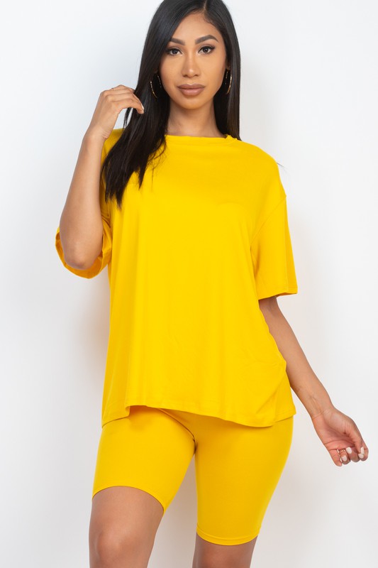 Women's oversized two-piece lounge set featuring a relaxed fit short-sleeve tee and high-waisted biker shorts, available in multiple vibrant colors. Perfect for casual wear, workouts, or athleisure style.