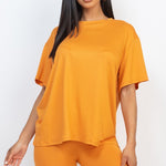 Women's oversized two-piece lounge set featuring a relaxed fit short-sleeve tee and high-waisted biker shorts, available in multiple vibrant colors. Perfect for casual wear, workouts, or athleisure style.