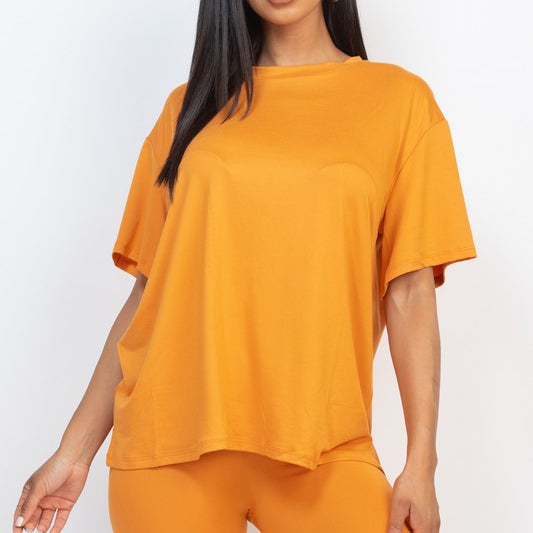 Women's oversized two-piece lounge set featuring a relaxed fit short-sleeve tee and high-waisted biker shorts, available in multiple vibrant colors. Perfect for casual wear, workouts, or athleisure style.