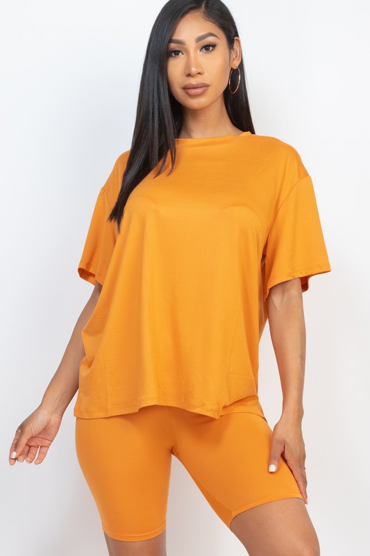 Women's oversized two-piece lounge set featuring a relaxed fit short-sleeve tee and high-waisted biker shorts, available in multiple vibrant colors. Perfect for casual wear, workouts, or athleisure style.