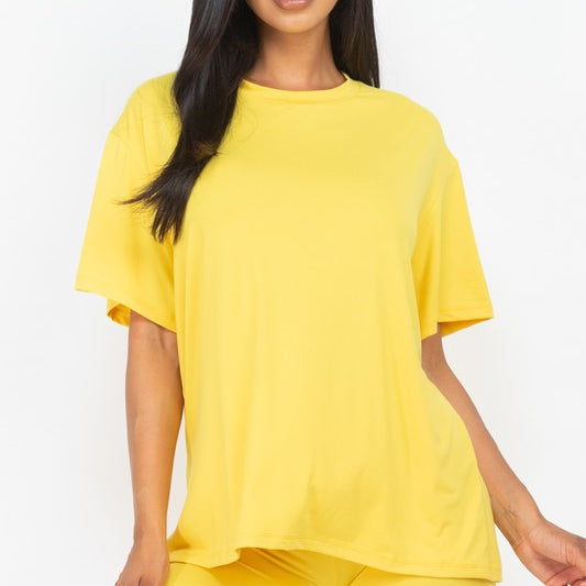 Women's oversized two-piece lounge set featuring a relaxed fit short-sleeve tee and high-waisted biker shorts, available in multiple vibrant colors. Perfect for casual wear, workouts, or athleisure style.