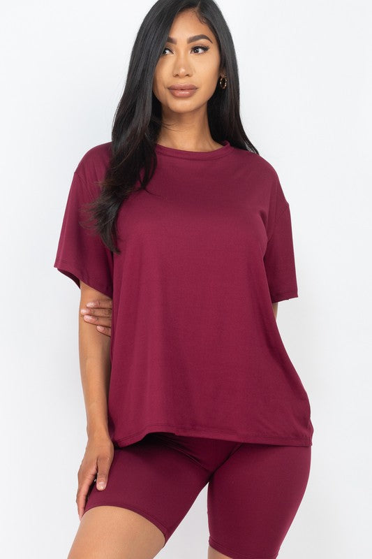 Women's oversized two-piece lounge set featuring a relaxed fit short-sleeve tee and high-waisted biker shorts, available in multiple vibrant colors. Perfect for casual wear, workouts, or athleisure style.