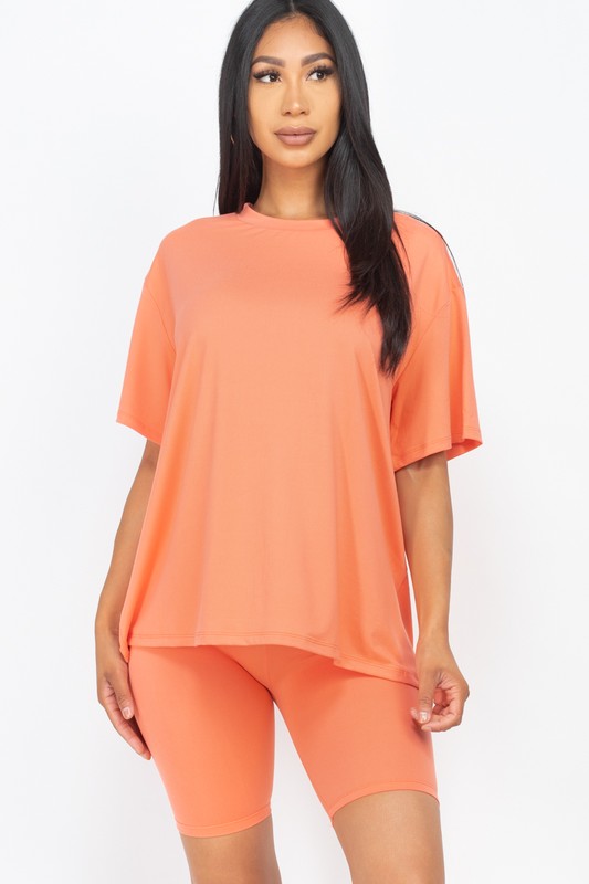 Women's oversized two-piece lounge set featuring a relaxed fit short-sleeve tee and high-waisted biker shorts, available in multiple vibrant colors. Perfect for casual wear, workouts, or athleisure style.