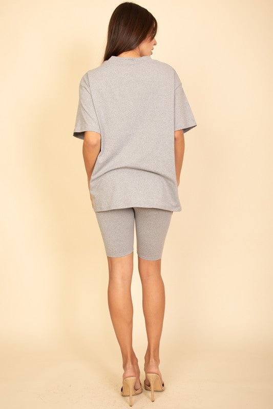 Women's oversized two-piece lounge set featuring a relaxed fit short-sleeve tee and high-waisted biker shorts, available in multiple vibrant colors. Perfect for casual wear, workouts, or athleisure style.