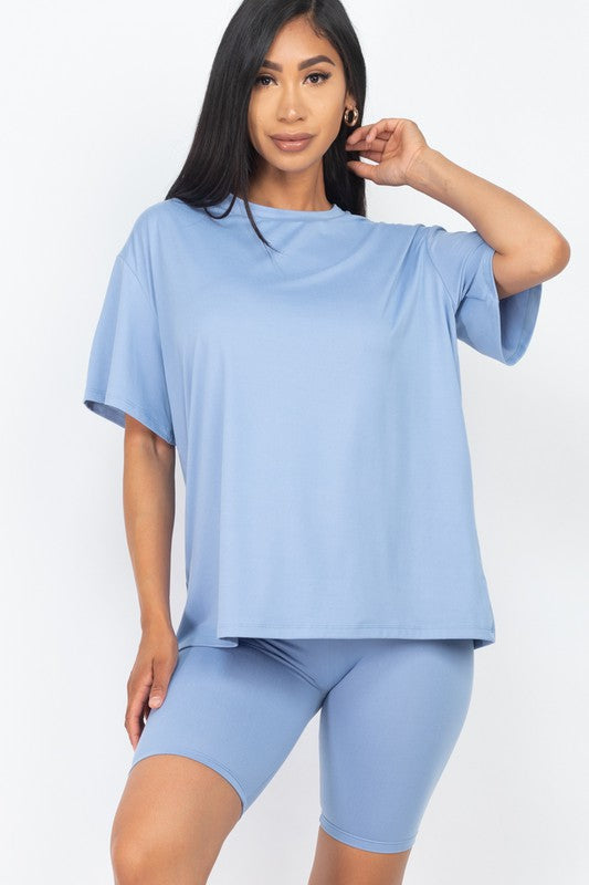 Women's oversized two-piece lounge set featuring a relaxed fit short-sleeve tee and high-waisted biker shorts, available in multiple vibrant colors. Perfect for casual wear, workouts, or athleisure style.