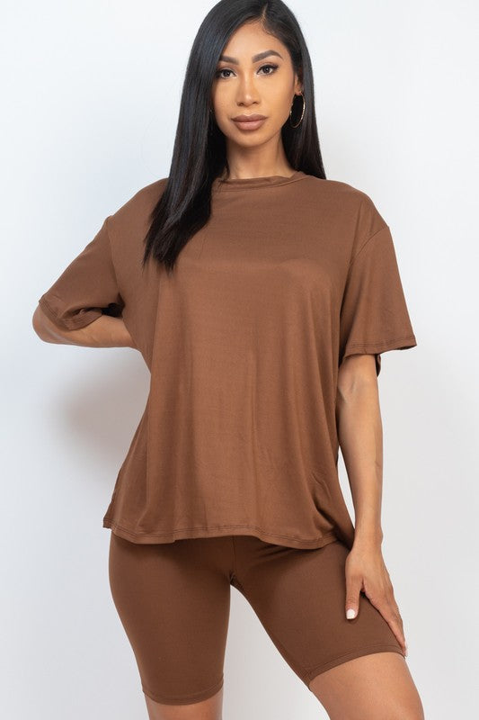Women's oversized two-piece lounge set featuring a relaxed fit short-sleeve tee and high-waisted biker shorts, available in multiple vibrant colors. Perfect for casual wear, workouts, or athleisure style.