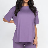 Women's oversized two-piece lounge set featuring a relaxed fit short-sleeve tee and high-waisted biker shorts, available in multiple vibrant colors. Perfect for casual wear, workouts, or athleisure style.