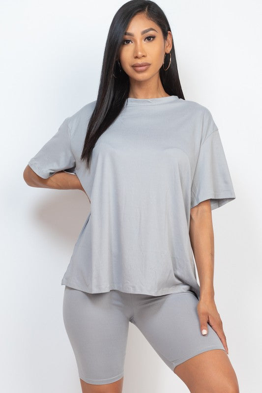 Women's oversized two-piece lounge set featuring a relaxed fit short-sleeve tee and high-waisted biker shorts, available in multiple vibrant colors. Perfect for casual wear, workouts, or athleisure style.