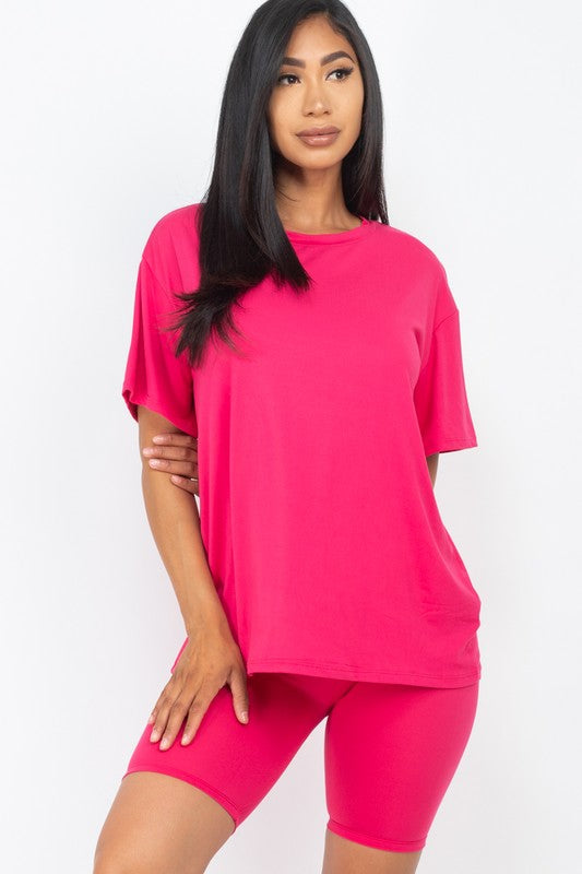 Women's oversized two-piece lounge set featuring a relaxed fit short-sleeve tee and high-waisted biker shorts, available in multiple vibrant colors. Perfect for casual wear, workouts, or athleisure style.