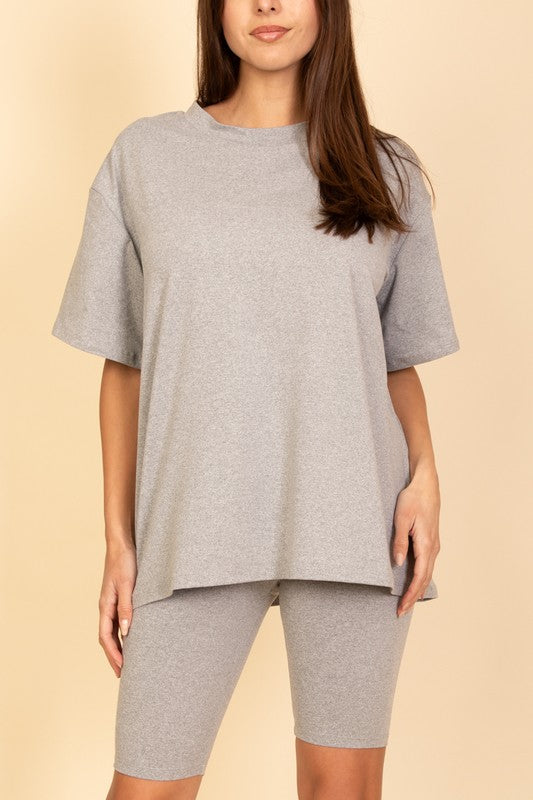 Women's oversized two-piece lounge set featuring a relaxed fit short-sleeve tee and high-waisted biker shorts, available in multiple vibrant colors. Perfect for casual wear, workouts, or athleisure style.