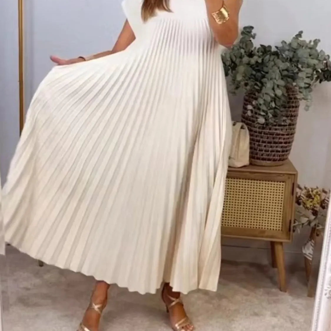 Women's beige pleated maxi dress with cap sleeves and side pockets – elegant flowy summer dress for casual or vacation wear.