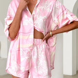 Women's blush pink tropical lily stripe two-piece outfit with loose button shirt and comfy drawstring shorts for resort wear.