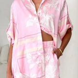 Women's blush pink tropical lily stripe two-piece outfit with loose button shirt and comfy drawstring shorts for resort wear.