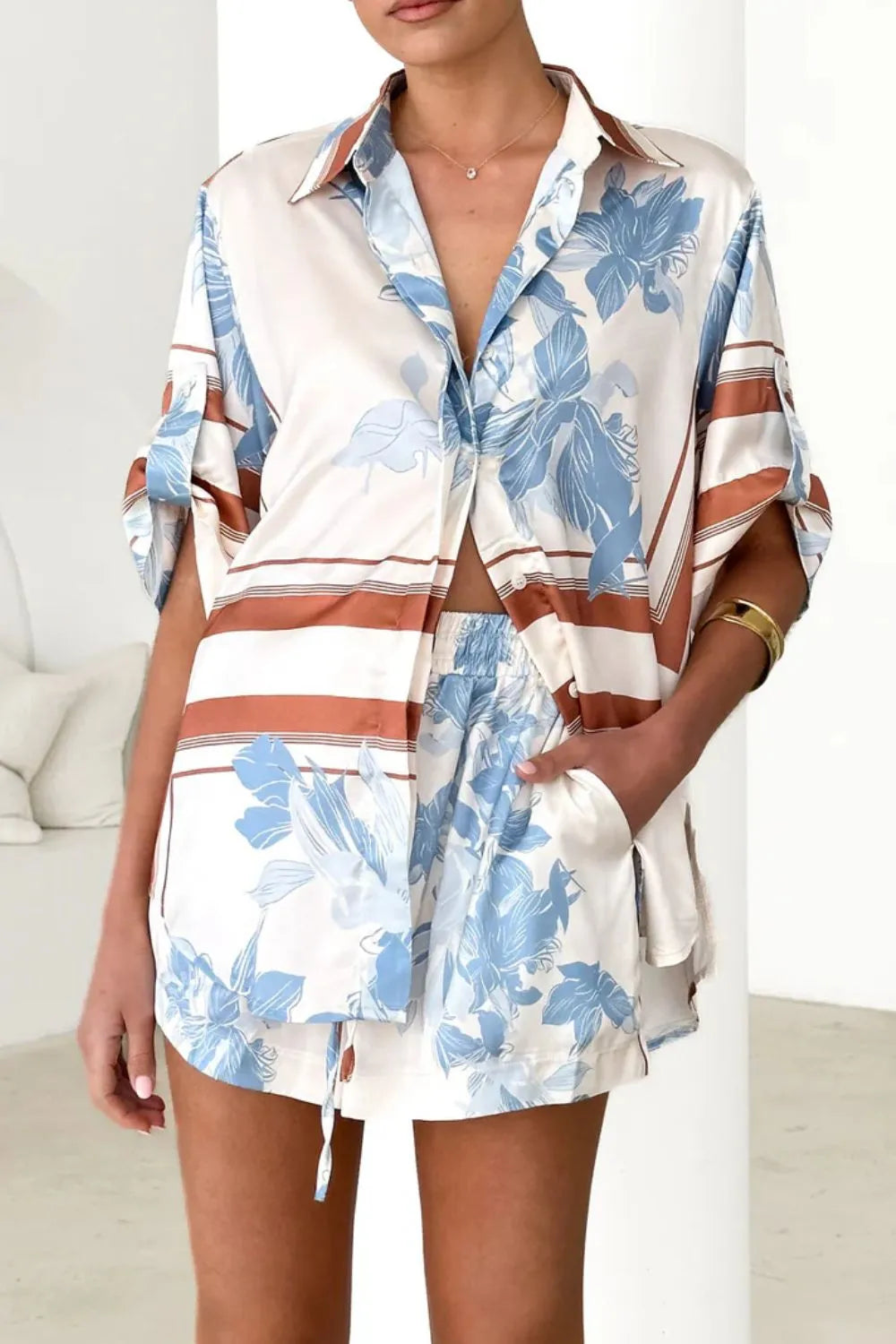 Women's ivory and sky-blue floral stripe Co-Ord set with oversized collared shirt and high-waist shorts – breezy summer matching set.