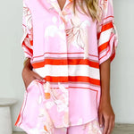 Women's blush pink tropical lily stripe two-piece outfit with loose button shirt and comfy drawstring shorts for resort wear.