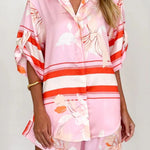 Women's blush pink tropical lily stripe two-piece outfit with loose button shirt and comfy drawstring shorts for resort wear.