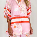 Women's blush pink tropical lily stripe two-piece outfit with loose button shirt and comfy drawstring shorts for resort wear.