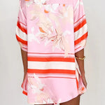Women's blush pink tropical lily stripe two-piece outfit with loose button shirt and comfy drawstring shorts for resort wear.