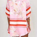 Women's blush pink tropical lily stripe two-piece outfit with loose button shirt and comfy drawstring shorts for resort wear.