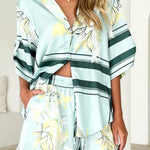 Women's seafoam green tropical floral shirt and shorts set featuring relaxed short-sleeve button shirt and elastic waist shorts.