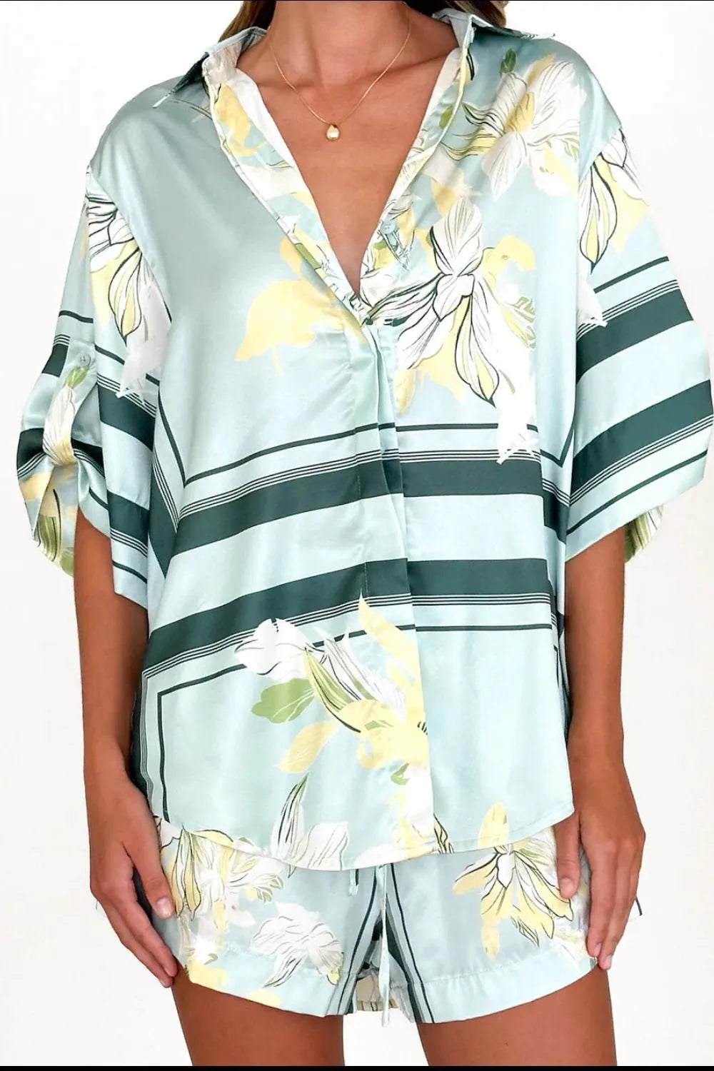 Women's seafoam green tropical floral shirt and shorts set featuring relaxed short-sleeve button shirt and elastic waist shorts.