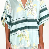 Women's seafoam green tropical floral shirt and shorts set featuring relaxed short-sleeve button shirt and elastic waist shorts.