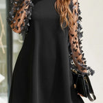 Women's black mini dress with sheer mesh long sleeves and 3D floral appliqués – elegant A-line cocktail dress for parties and special occasions