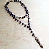 Double strand blue lapis lazuli bead necklace with natural gold and gray flecks, displayed on a light wooden surface.