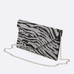 Front view of black and silver rhinestone zebra print clutch with envelope-style flap and silver chain strap.