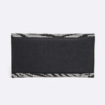 Back view of black and silver rhinestone zebra print clutch with envelope-style flap and silver chain strap.